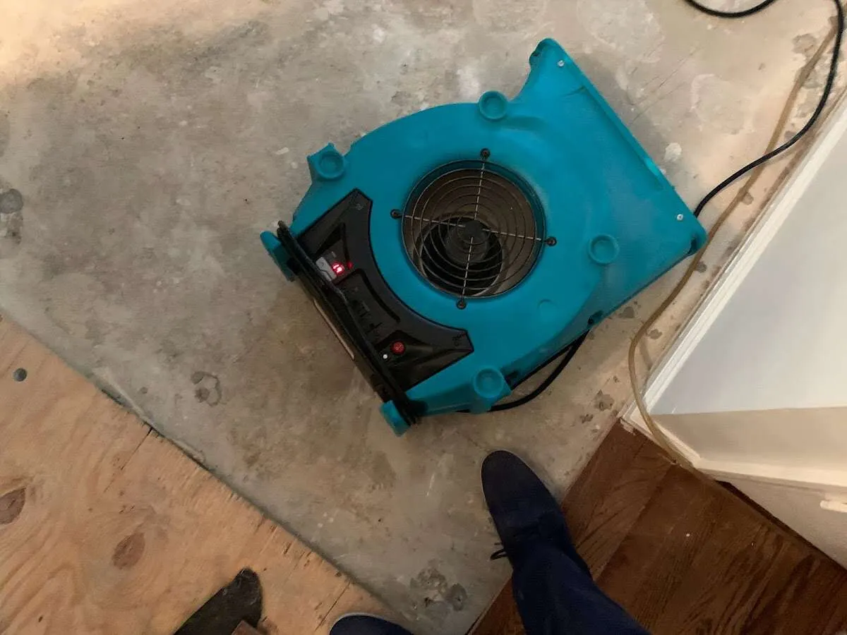Air mover drying subfloor during Leak Detection & Repair in Windsor Heights